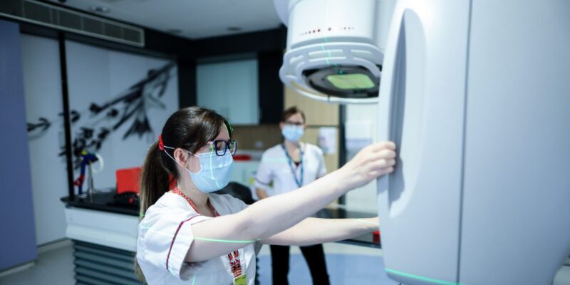 Staff with radiotherapy machine