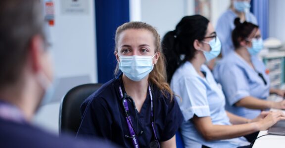 Four children's emergency department staff working at desk