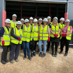 Theatre team on the building site wearing hard hats