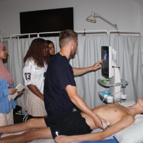 Doctor showing pupils around an ultrasound test.