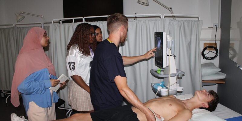 Doctor showing pupils around an ultrasound test.