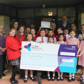 School pupils presenting the cheque