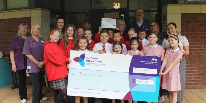 School pupils presenting the cheque